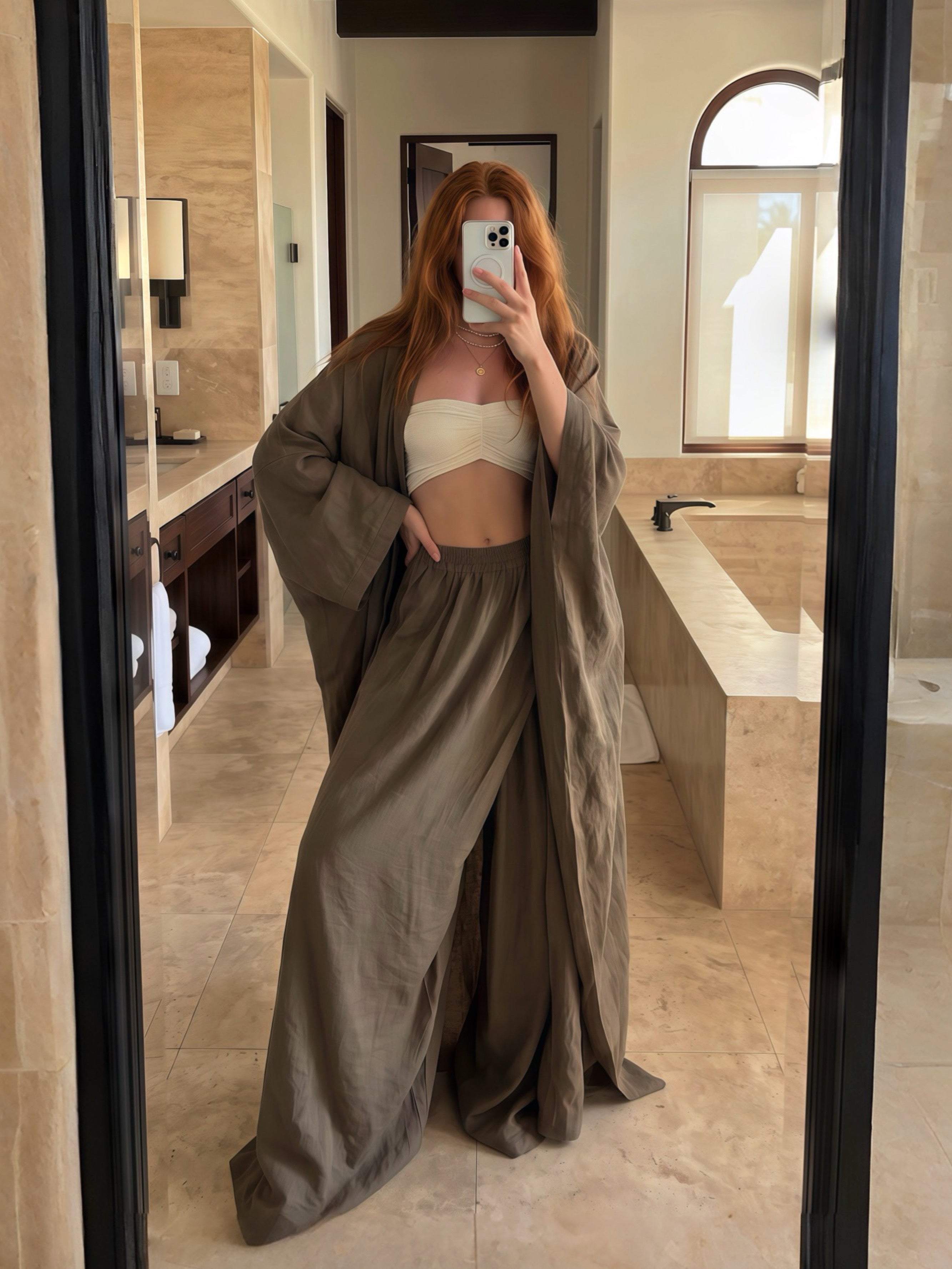 woman wearing a green olive long robe standing with oversized olive pants resort outfit boho style