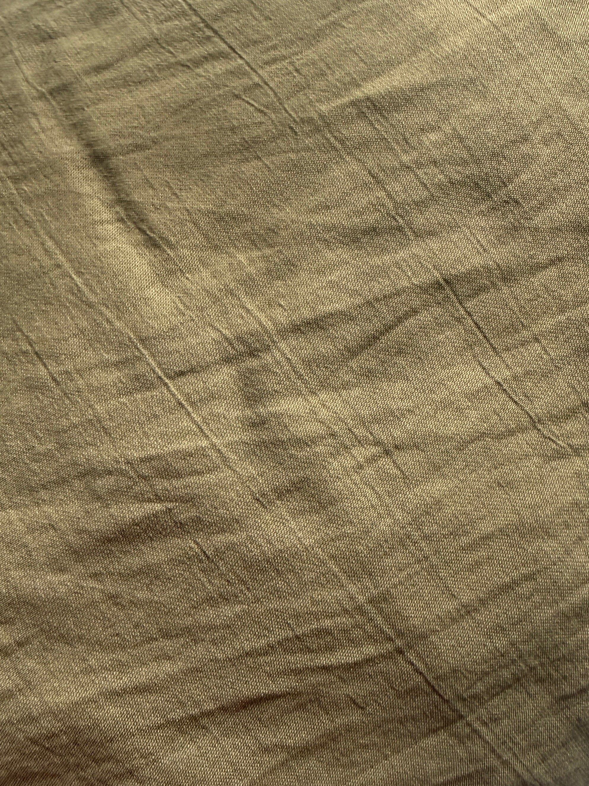 Close-up of textured brown olive fabric with visible