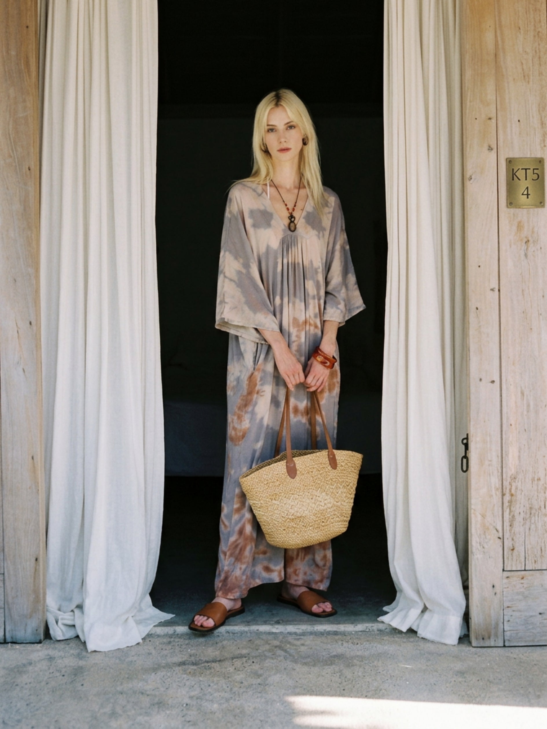 Woman wearing seafoam sand tie dye kaftan maxi dress, flowy resort wear beach cover up, lightweight semi-sheer vacation dress